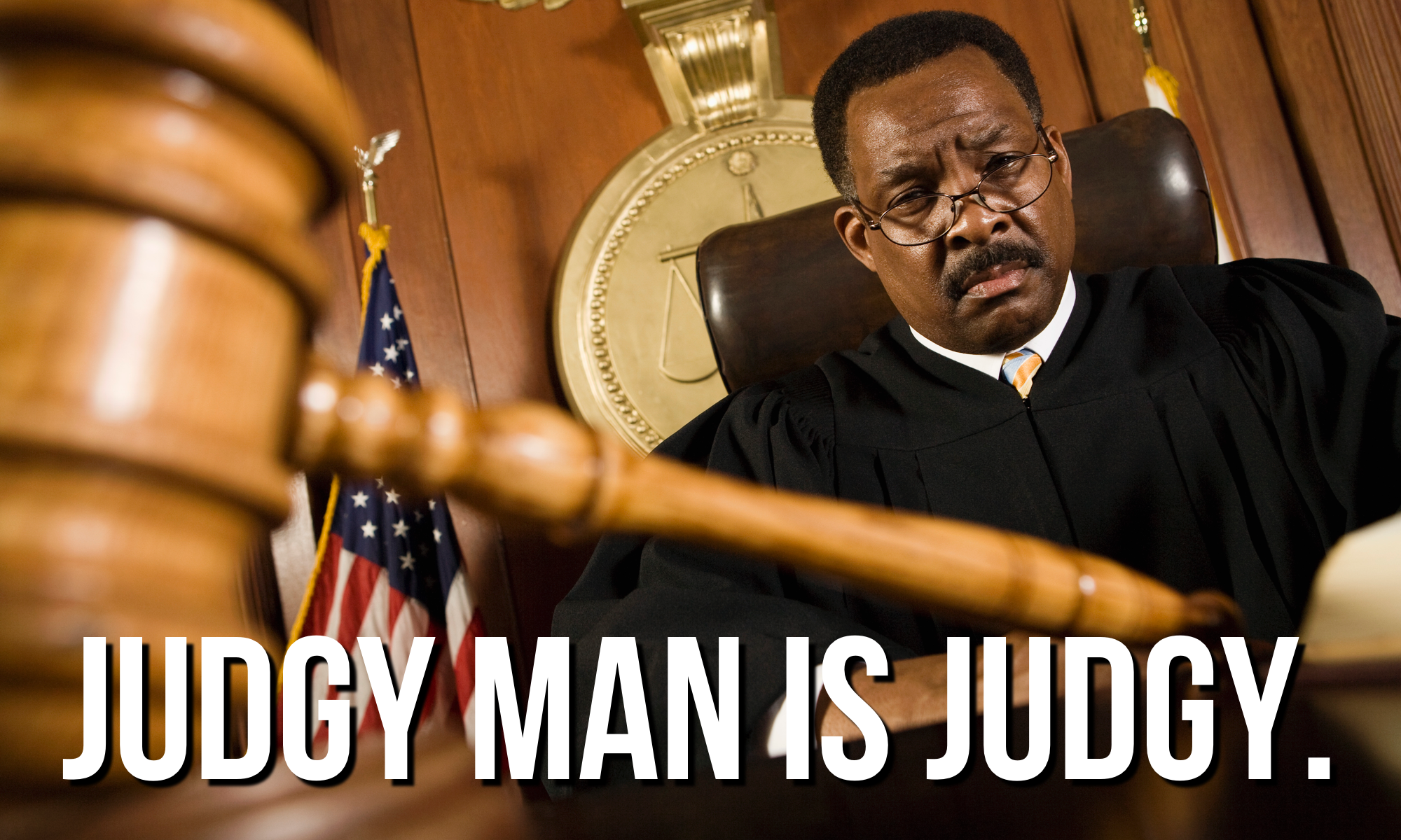 A very concerned-looking man in a judge's robe with a gavel in the foreground. Overlaid with the words "Judgy Man Is Judgy."